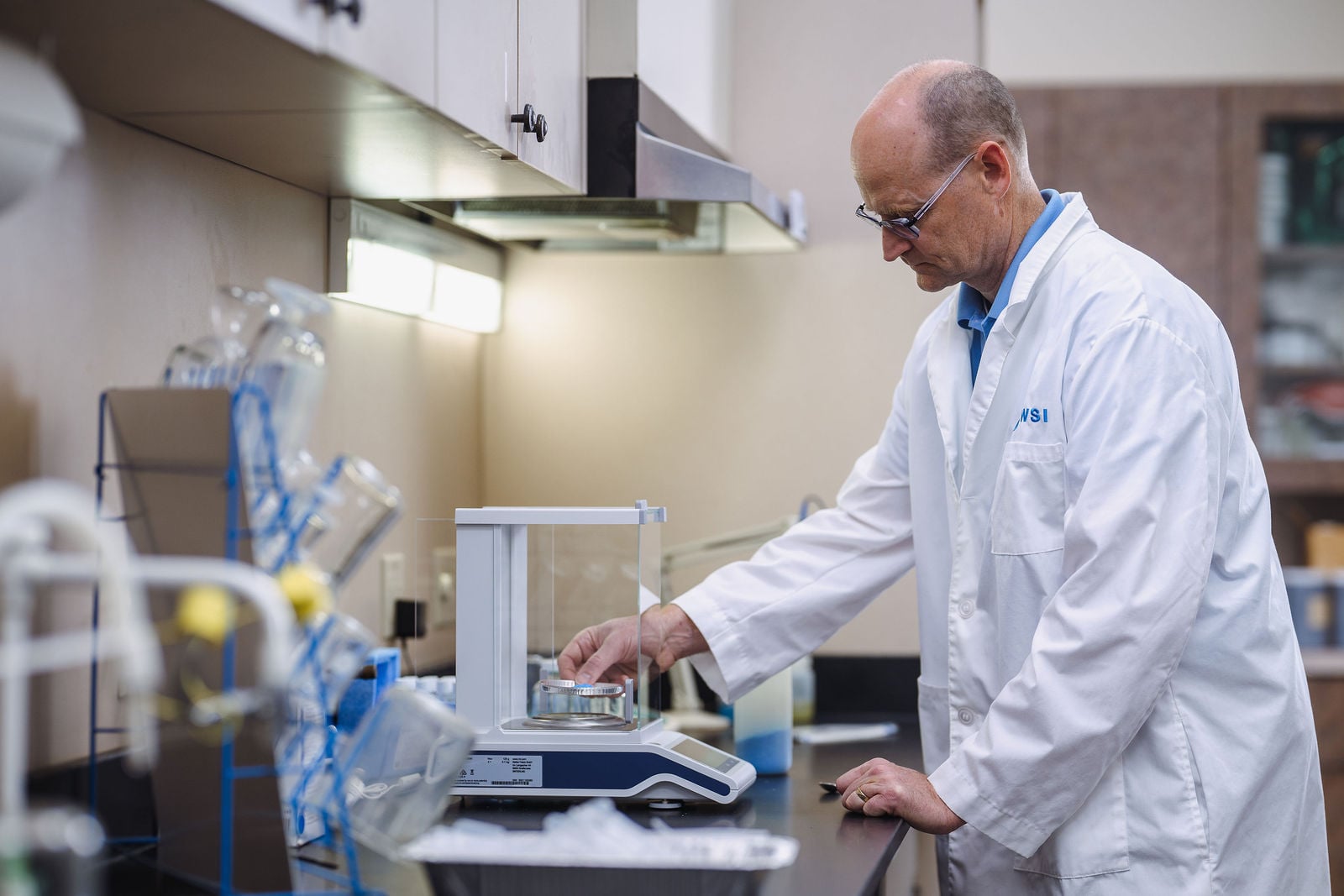 WSI scientist using precision scale in quality testing laboratory