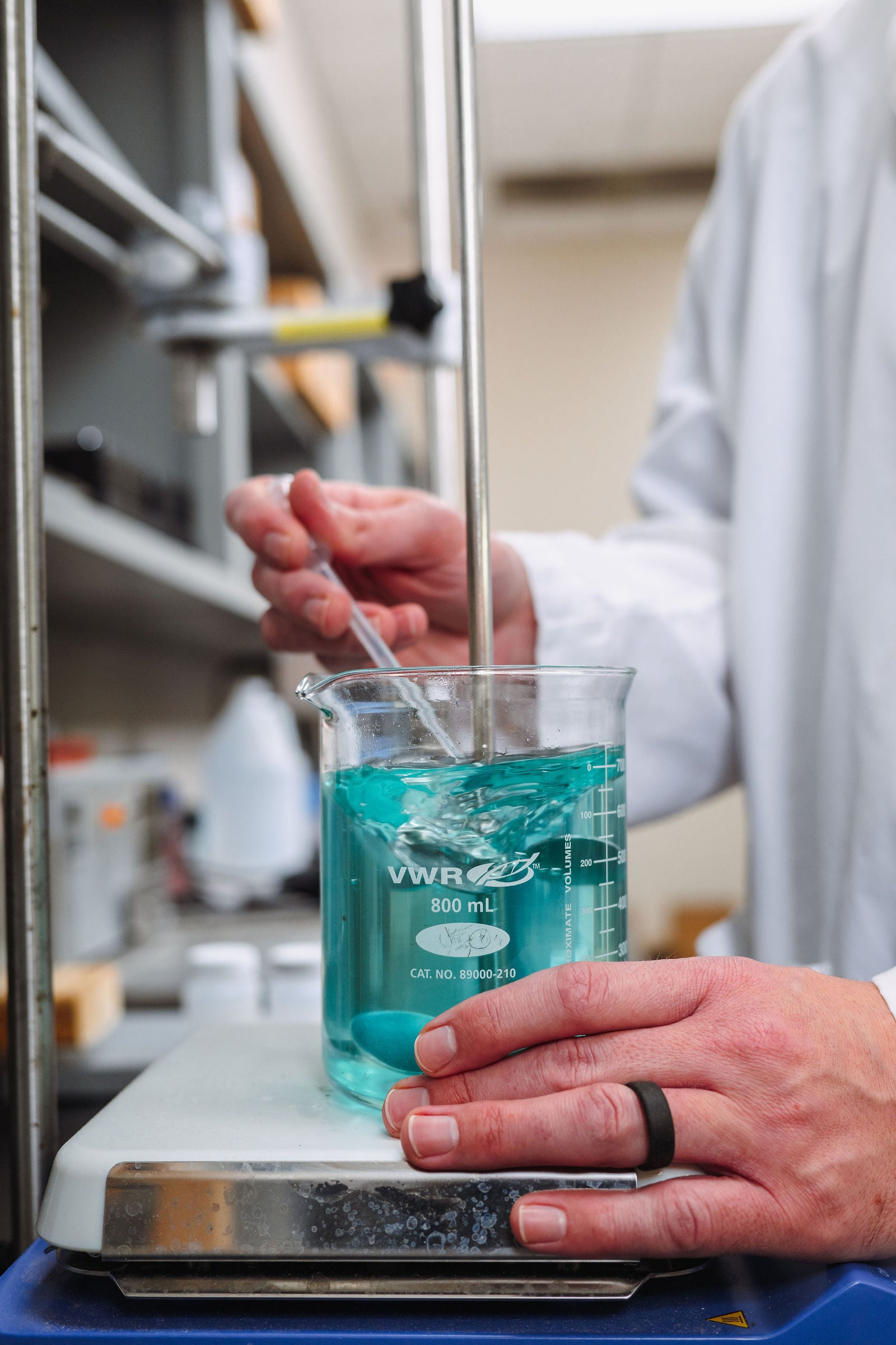 Lab technician mixing chemical solution in beaker