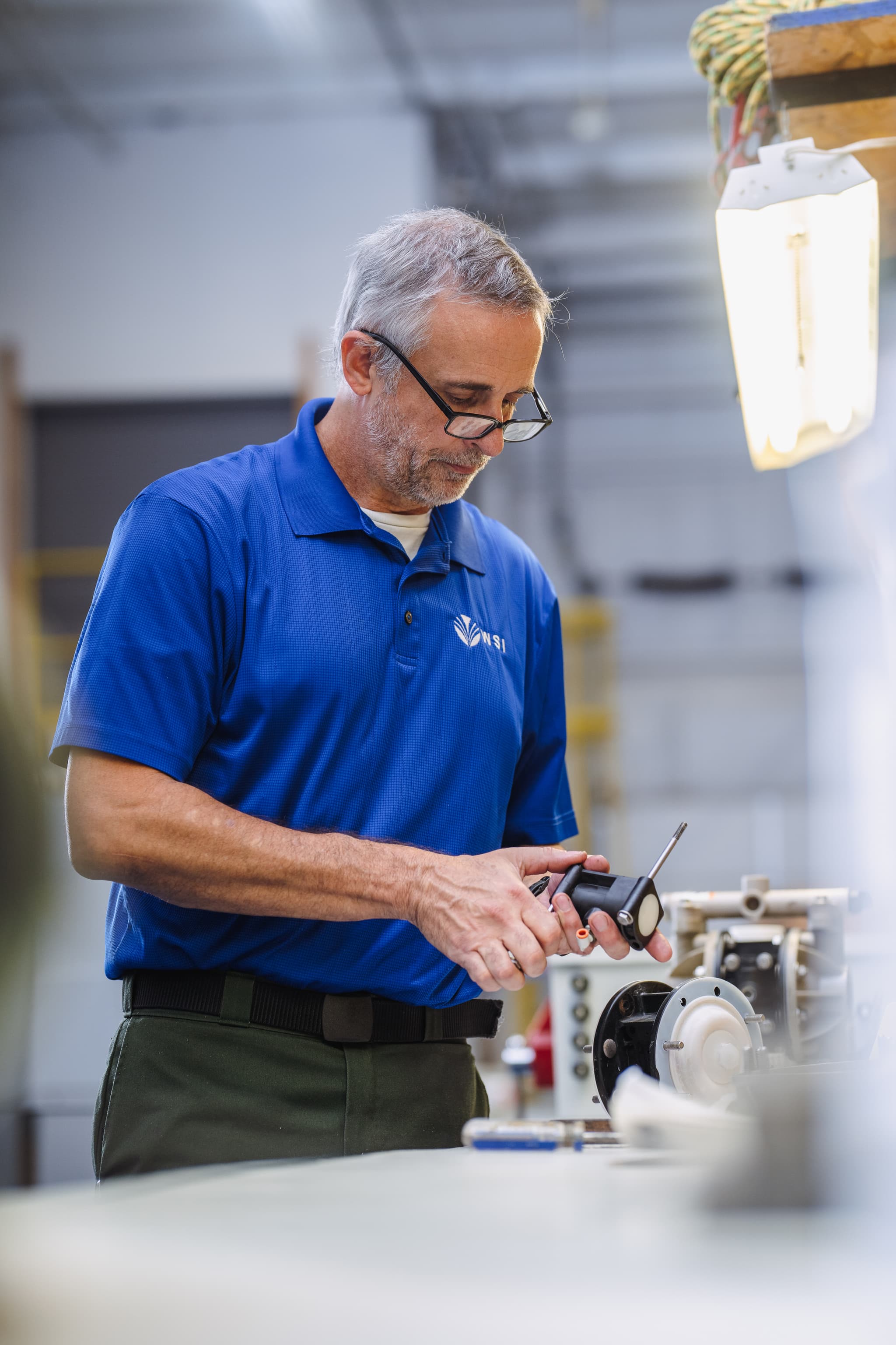WSI technician servicing industrial laundry equipment