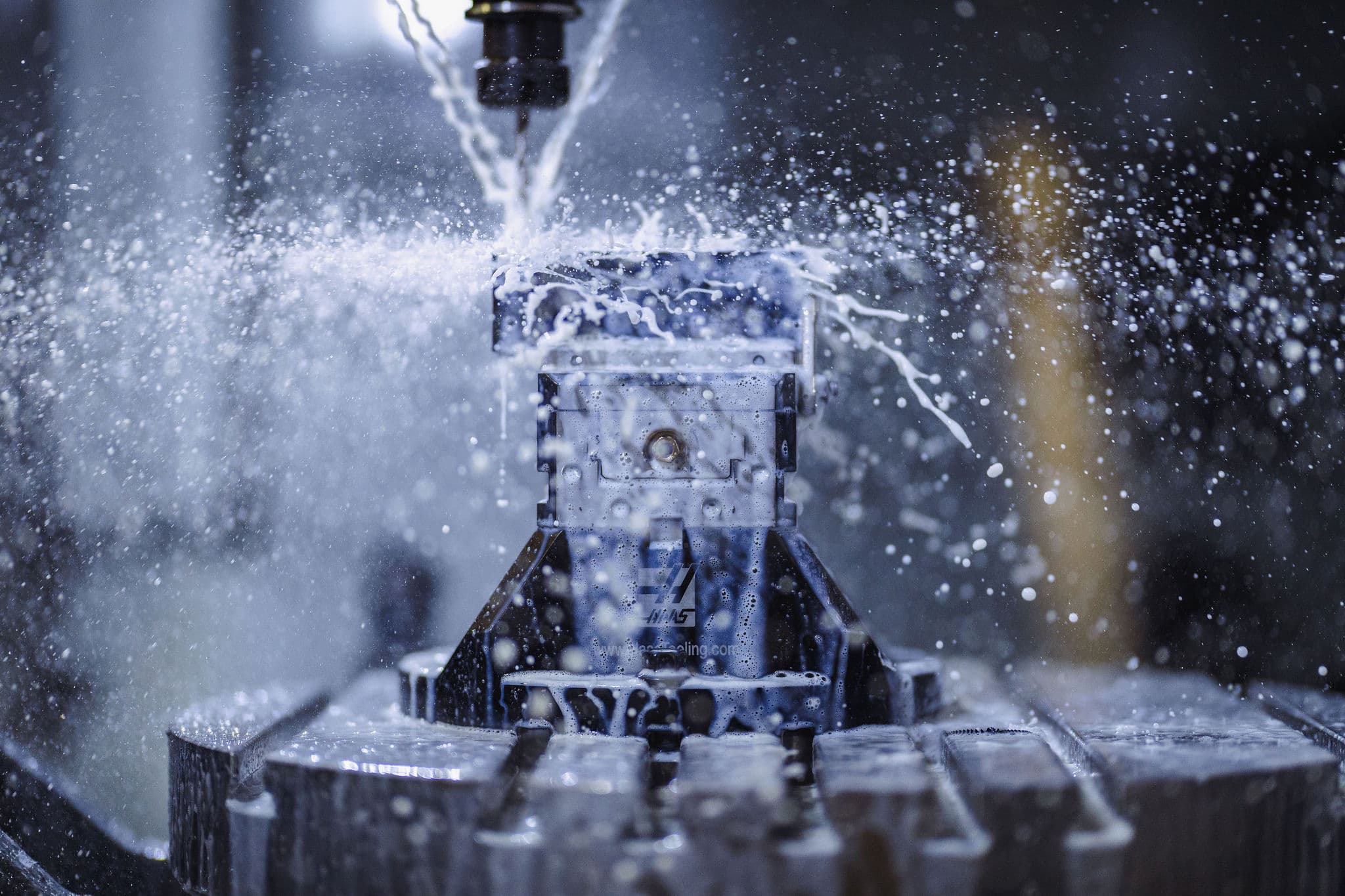 HAAS UMC-1000 five-axis machining center cutting a part in WSI's machine shop